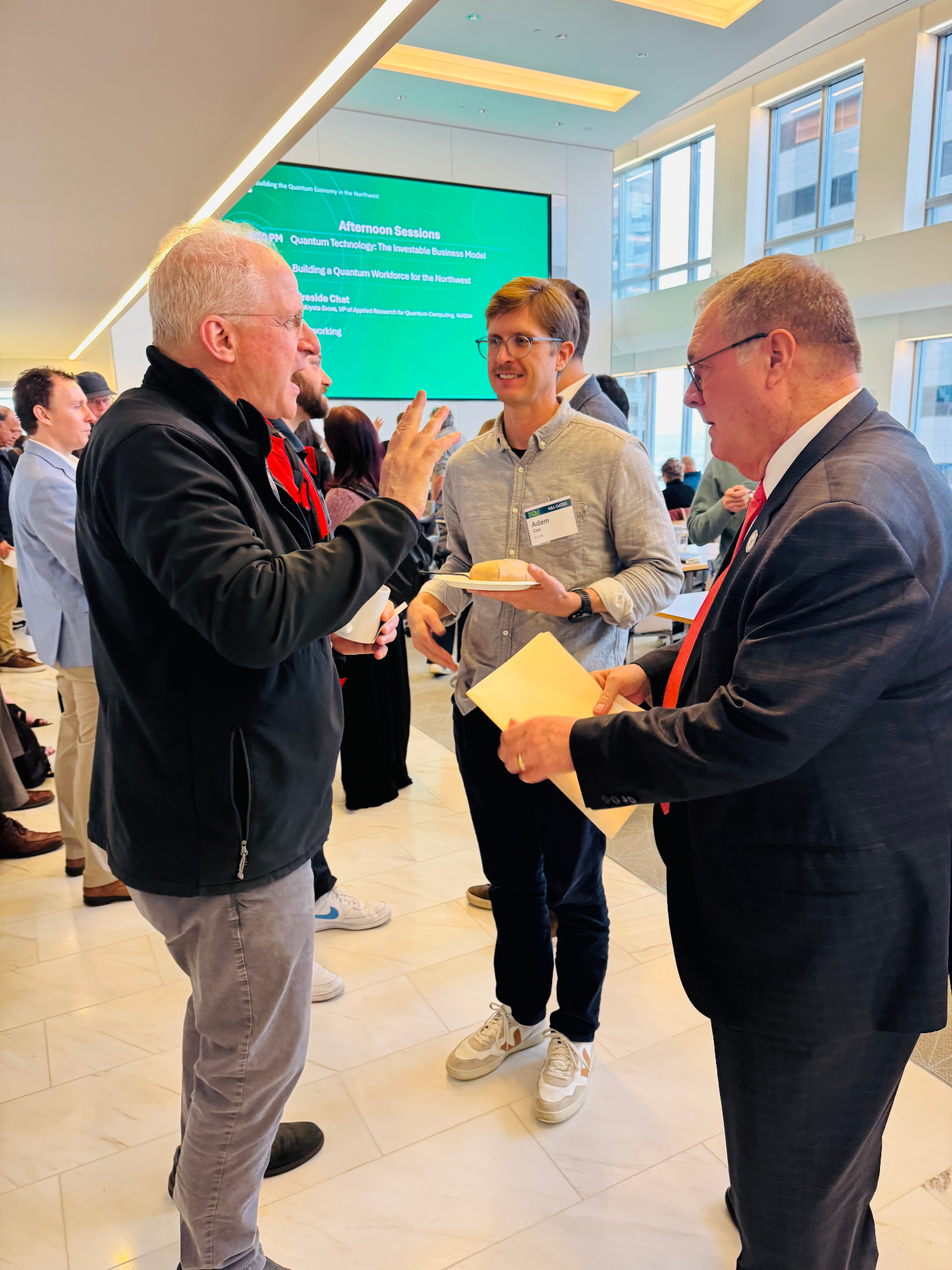 Attendees in conversation during a networking break at Northwest Quantum Day.